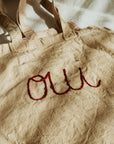 Hand embroidered, plant dyed tote bag: Oui